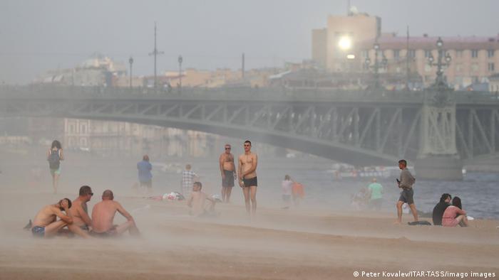 Люди на набережной Невы во время песчаной бури 15 июля 2021 года