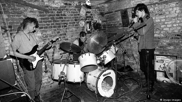 Музыканты панк-рок-группы играют и поют в подвале